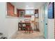Basement art studio with exposed brick accent wall and neutral tile flooring at 3415 N Vine St, Denver, CO 80205