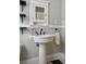 Charming bathroom with pedestal sink, medicine cabinet, and classic fixtures at 3415 N Vine St, Denver, CO 80205