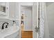 Elegant bathroom with a white sink, hardwood floors, and a view to another room at 3415 N Vine St, Denver, CO 80205