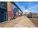 Exterior building wall with a vibrant mural and a sidewalk, located on a street at 3415 N Vine St, Denver, CO 80205