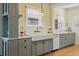 Bright, updated kitchen with a farmhouse sink, subway tile backsplash, and modern cabinetry at 3415 N Vine St, Denver, CO 80205