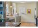 Charming kitchen with farmhouse sink, gray cabinets, marble counters, and stainless steel appliances at 3415 N Vine St, Denver, CO 80205