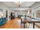 Bright living room featuring hardwood floors, neutral paint, and a dining space with natural light at 3415 N Vine St, Denver, CO 80205