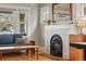 Living room featuring a cozy couch, hardwood floors and stylish fireplace at 3415 N Vine St, Denver, CO 80205