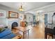 Open-concept living room showcasing hardwood floors and a charming fireplace at 3415 N Vine St, Denver, CO 80205