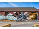 Exterior of building featuring a mural of a musician playing guitar in a vibrant outdoor area at 3415 N Vine St, Denver, CO 80205