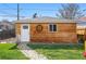 Backyard storage shed with wood siding, a white door, and a decorative wheel feature at 3415 N Vine St, Denver, CO 80205