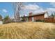 Large backyard featuring a brick home, open yard, deck, and patio at 6847 S Hill St, Littleton, CO 80120