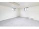 Unfinished basement featuring new carpet, a radiator, and two windows for fresh air and natural light at 6847 S Hill St, Littleton, CO 80120