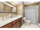 Elegant bathroom with a granite countertop vanity, a large mirror, and a shower with patterned curtain at 6847 S Hill St, Littleton, CO 80120