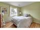 Comfortable bedroom with hardwood floors, soft lighting, and a window with a pleasant outdoor view at 6847 S Hill St, Littleton, CO 80120