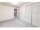 Clean and bright bedroom with neutral carpet, closet space, and doorway to another area at 6847 S Hill St, Littleton, CO 80120