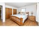 Bright bedroom features hardwood floors, natural light, and double closets for ample storage at 6847 S Hill St, Littleton, CO 80120