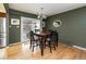 Cozy dining room with hardwood floors, dark wood table, and sliding door to backyard at 6847 S Hill St, Littleton, CO 80120