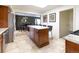 Open-concept kitchen with stainless steel appliances, tile flooring, access to dining and living room at 6847 S Hill St, Littleton, CO 80120