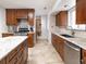 Stylish kitchen with stainless steel appliances, granite countertops and access to the living room at 6847 S Hill St, Littleton, CO 80120
