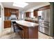 Well-lit kitchen features granite countertops, stainless steel appliances and stylish tile flooring at 6847 S Hill St, Littleton, CO 80120
