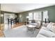 Bright living room featuring hardwood floors, neutral furniture, and a dining area at 6847 S Hill St, Littleton, CO 80120