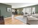 Bright living room featuring hardwood floors, neutral furniture, and a dining area at 6847 S Hill St, Littleton, CO 80120
