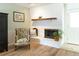 Cozy living room showcasing a painted brick fireplace and comfortable seating area, perfect for relaxation at 6847 S Hill St, Littleton, CO 80120