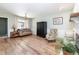 Bright living room featuring wood flooring, a modern color scheme and a chandelier at 6847 S Hill St, Littleton, CO 80120