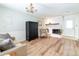 Bright living room featuring wood flooring, a fireplace and a chandelier at 6847 S Hill St, Littleton, CO 80120