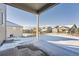 Backyard view with snow, fencing, and neighboring homes at 42367 Glen Abbey Dr, Elizabeth, CO 80107