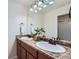 Bathroom with double vanity, granite countertops, and a decorative plant at 42367 Glen Abbey Dr, Elizabeth, CO 80107