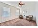 Cozy room features ceiling fan, seating, mirror and lots of natural light at 42367 Glen Abbey Dr, Elizabeth, CO 80107