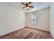 Cozy carpeted bedroom featuring a ceiling fan and natural light from a window at 42367 Glen Abbey Dr, Elizabeth, CO 80107