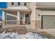 Close up view of a home's facade featuring a covered porch with stone accents and neutral siding at 42367 Glen Abbey Dr, Elizabeth, CO 80107