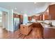 Well-lit kitchen featuring granite countertops, stainless steel appliances, ample cabinet space, and hardwood floors at 42367 Glen Abbey Dr, Elizabeth, CO 80107