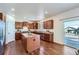 Well-lit kitchen featuring granite countertops, ample cabinet space, and hardwood floors with access to backyard at 42367 Glen Abbey Dr, Elizabeth, CO 80107