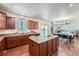 Kitchen island with granite countertops and hardwood floors leading to living and dining areas in an open floorplan at 42367 Glen Abbey Dr, Elizabeth, CO 80107