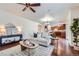 Inviting living room featuring hardwood floors, a comfortable sofa, and stylish decor with open floorplan at 42367 Glen Abbey Dr, Elizabeth, CO 80107