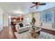 Inviting living room featuring hardwood floors, a comfortable sofa, and stylish decor with open floorplan at 42367 Glen Abbey Dr, Elizabeth, CO 80107