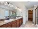 A main bathroom with double sinks, granite countertop, walk in shower, and soaking tub at 42367 Glen Abbey Dr, Elizabeth, CO 80107