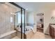 A modern bathroom with a glass shower enclosure, soaking tub, and neutral tile at 42367 Glen Abbey Dr, Elizabeth, CO 80107