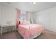 Charming bedroom with a pink bed, soft pink curtains, and a vintage-style desk at 14119 Glencoe St, Thornton, CO 80602