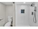 This renovated bathroom features a tiled shower with a mosaic glass inlay at 6631 E 77Th Pl, Commerce City, CO 80022