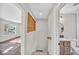 Bright hallway leading to a bathroom and living area with wood accents at 6631 E 77Th Pl, Commerce City, CO 80022