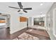 Open-concept living room with hardwood floors and recessed lighting, leading into kitchen at 6631 E 77Th Pl, Commerce City, CO 80022