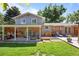 Backyard exterior of home featuring a covered patio with bbq grill, seating, and landscaping at 2117 S Balsam Ct, Lakewood, CO 80227