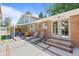 Backyard patio with outdoor seating, sun loungers, and views of the home's exterior and manicured landscaping at 2117 S Balsam Ct, Lakewood, CO 80227