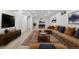 Finished basement with a large sectional sofa, media center, wood-look flooring, and bright lighting at 2117 S Balsam Ct, Lakewood, CO 80227