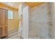 Bathroom featuring a tiled shower and natural wood plank walls and ceiling at 2117 S Balsam Ct, Lakewood, CO 80227