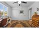 Bedroom with large window, ceiling fan, oriental rug, and closet with bifold doors at 2117 S Balsam Ct, Lakewood, CO 80227