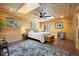 Bright bedroom featuring a decorative ceiling fan, skylight, and natural wood plank walls and ceiling at 2117 S Balsam Ct, Lakewood, CO 80227