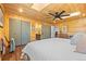 Bedroom featuring a ceiling fan, closet and ensuite featuring natural wood plank walls and ceiling at 2117 S Balsam Ct, Lakewood, CO 80227