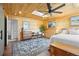 Bedroom featuring a ceiling fan, skylight, and natural wood plank walls and ceiling at 2117 S Balsam Ct, Lakewood, CO 80227
